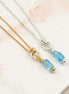 Two necklaces with blue beads on a light background