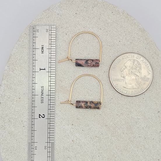 Pair of hoop earrings with brown rectangular stones on a gray surface with a ruler for scale.
