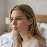 Woman with blonde hair and earrings in a softly lit room