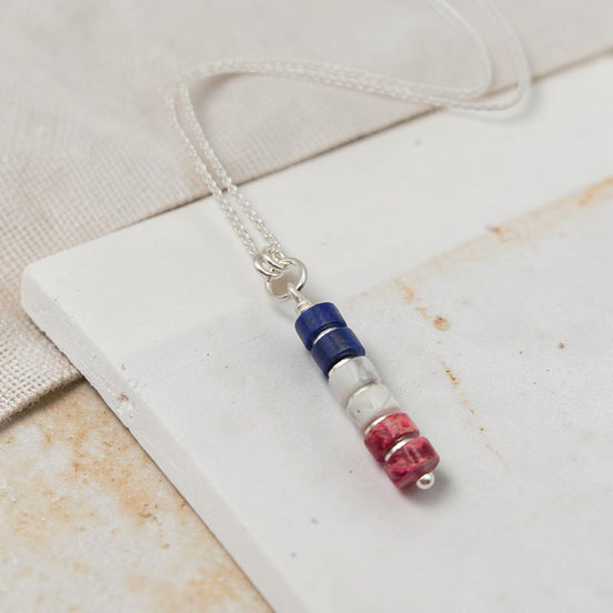 Necklace with colorful beads on a white surface