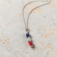 Necklace with colorful beads on a textured surface
