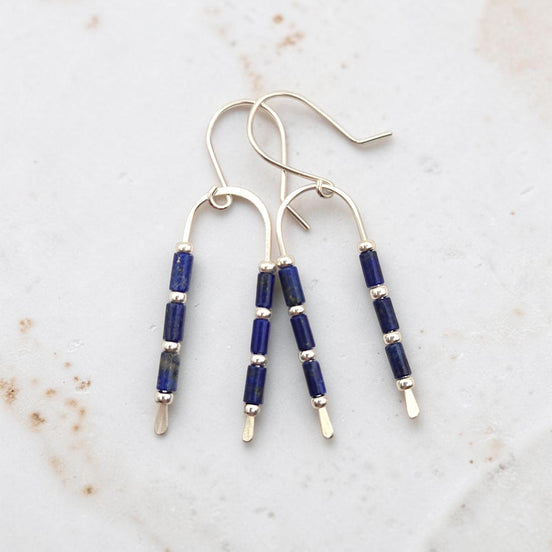 silver wishbone shaped earrings featuring lapis lazuli beads