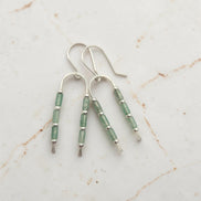 silver wishbone style earrings featuring green aventurine gemstone beads