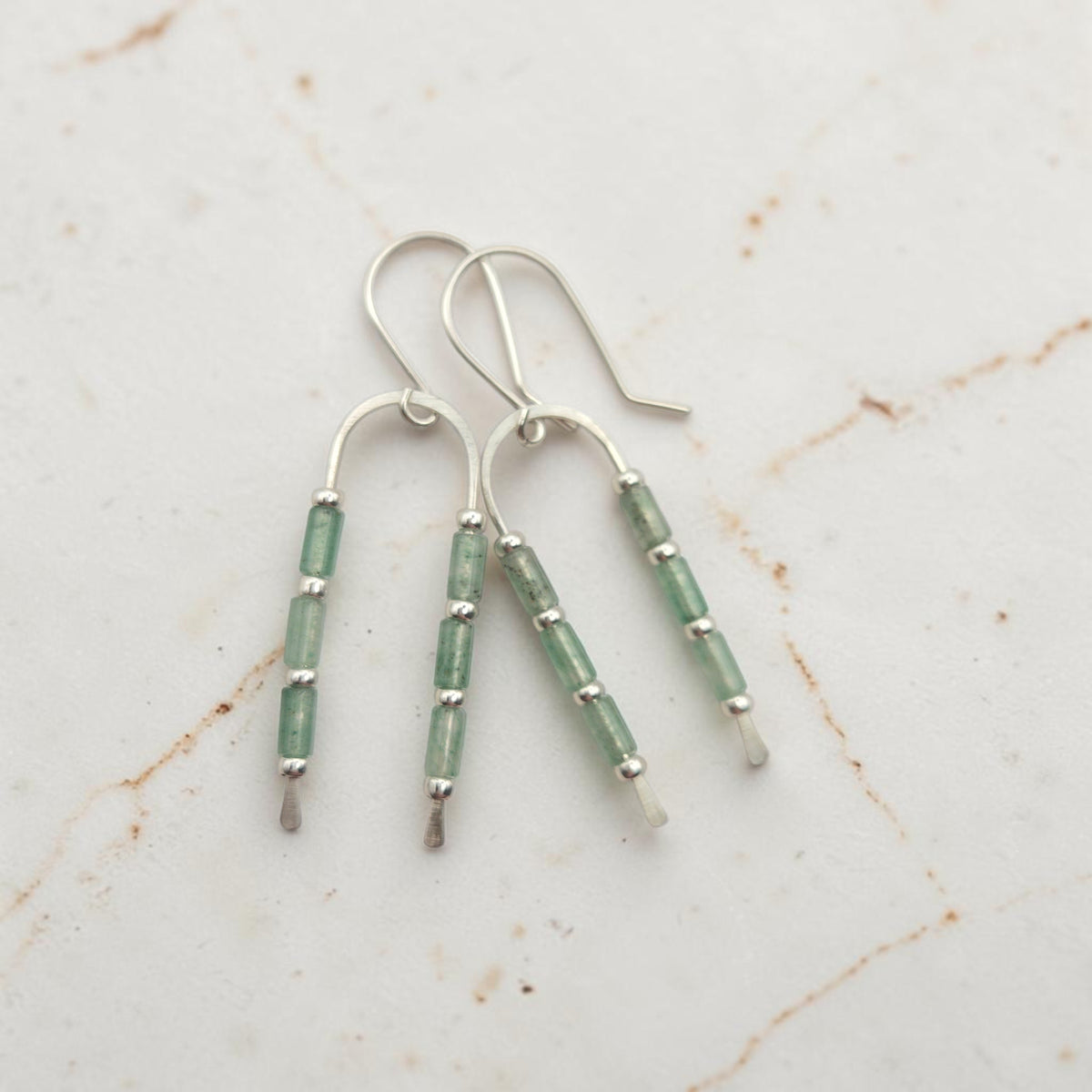 silver wishbone style earrings featuring green aventurine gemstone beads