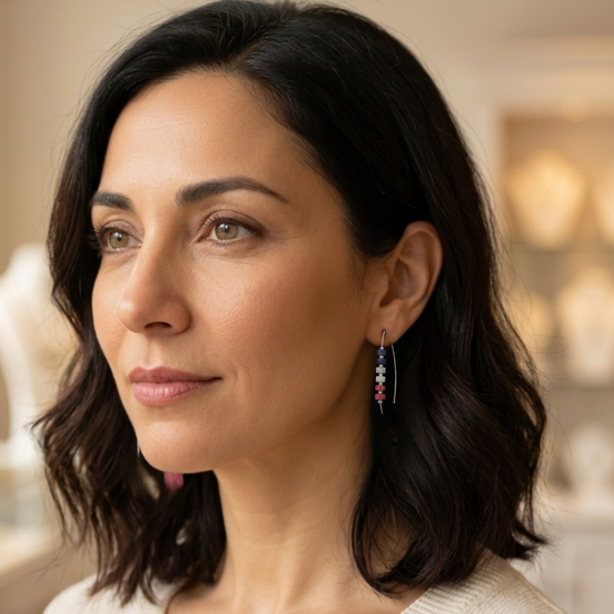 Woman wearing earrings with a blurred indoor background