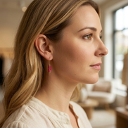 Woman wearing a red earring in an indoor setting