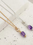 Two necklaces with purple beads on a textured surface