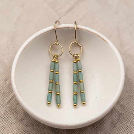 Bijou by SAM River Stone dangle earrings featuring Amazonite tube beads and 14k gold fill hoops on a white ceramic dish.
