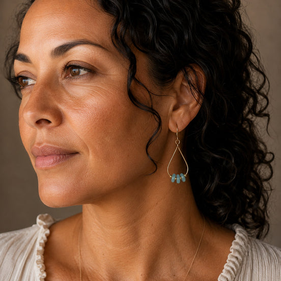 Bijou by SAM Northern Lights teardrop hoop earrings featuring aqua-green amazonite stones worn by a woman.