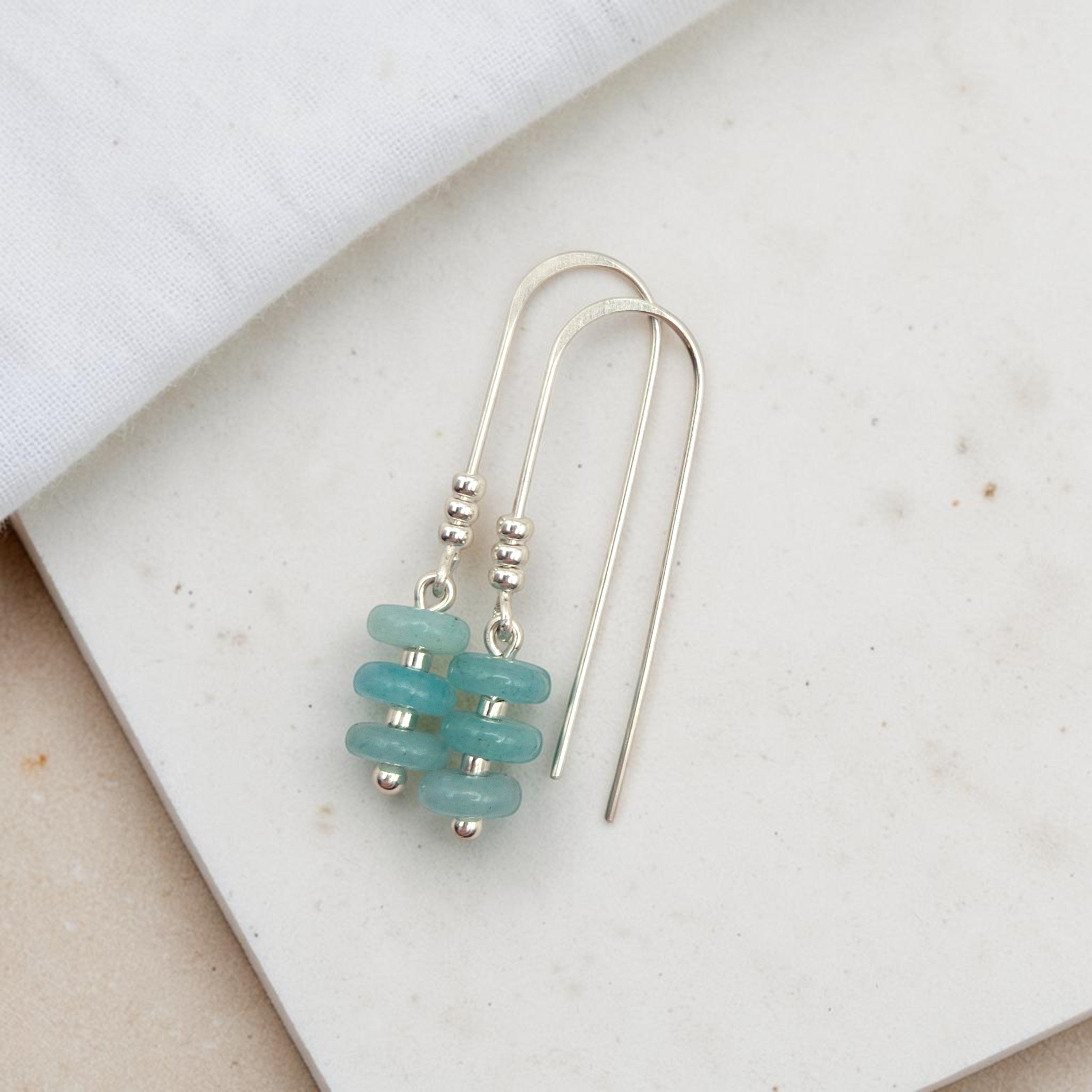 Bijou by SAM handmade sterling silver threader earrings featuring soft aqua-green amazonite beads on a white surface.