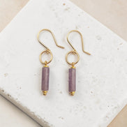Bijou by SAM Sophia earrings featuring purple amethyst cylinder stones on handcrafted 14k gold fill hoops.