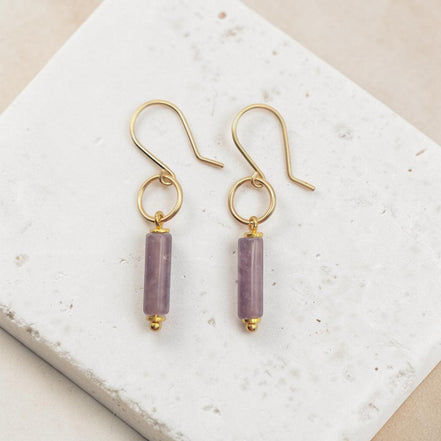 Bijou by SAM Sophia earrings featuring purple amethyst cylinder stones on handcrafted 14k gold fill hoops.