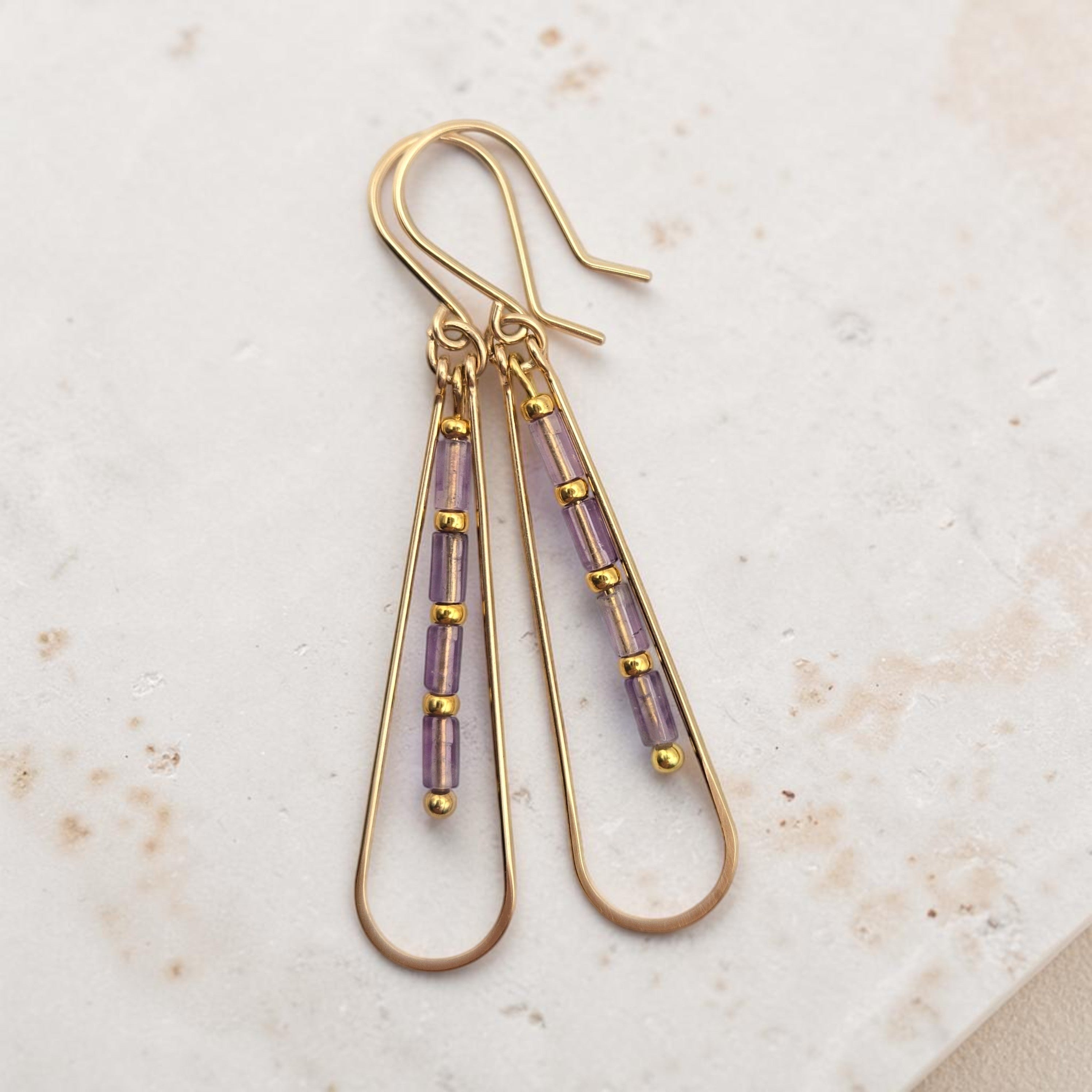 Bijou by SAM Twilight Ridge teardrop earrings featuring purple amethyst tube beads on 14k gold fill hoops.
