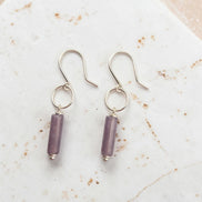 Bijou by SAM Sophia earrings featuring purple amethyst cylinder stones on handcrafted sterling silver hoops.