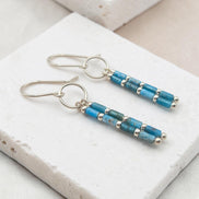 Bijou by SAM Still Water dangle earrings featuring blue apatite tube beads and sterling silver hoops on stone base.