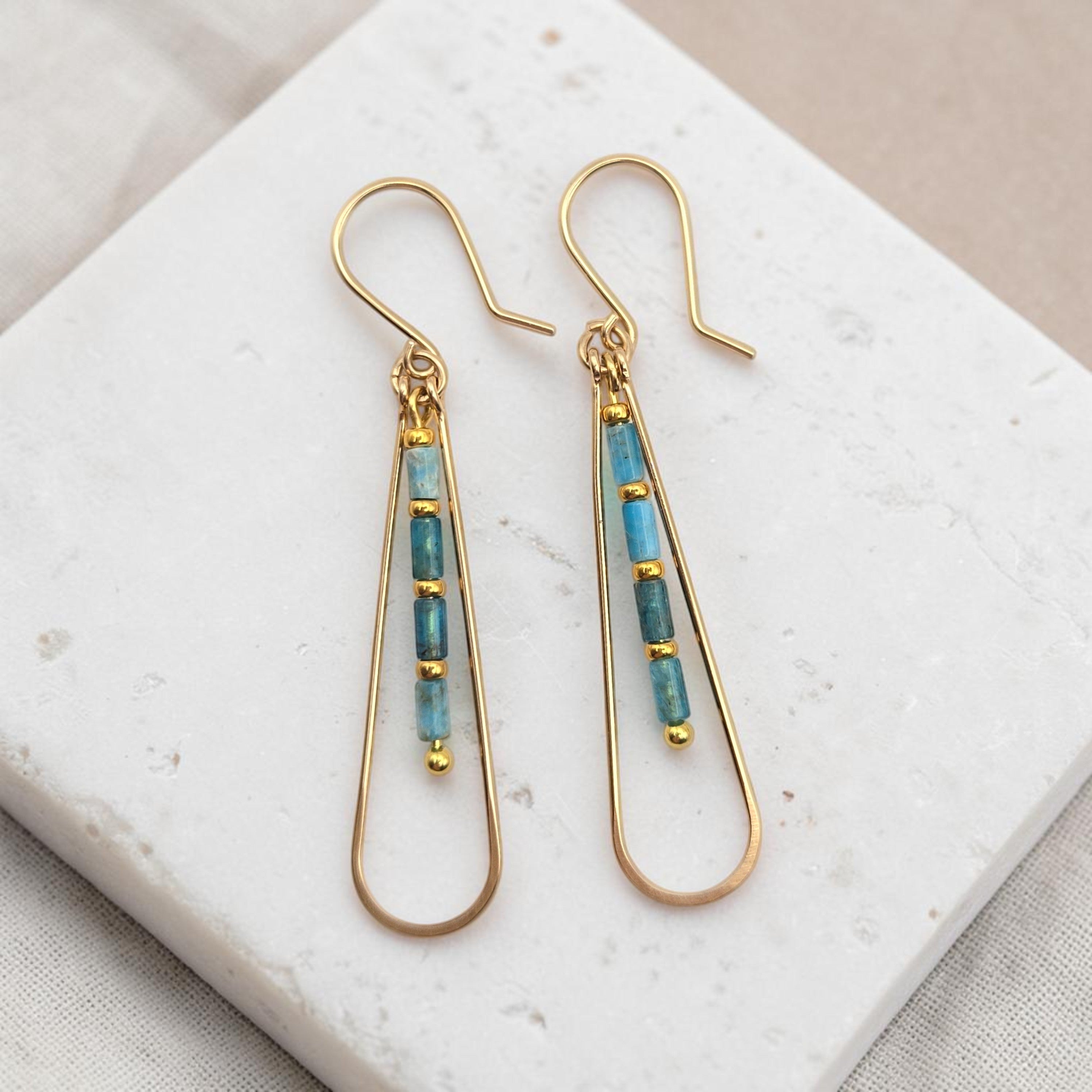Bijou by SAM Still Water teardrop earrings featuring blue Apatite tube beads and 14k gold fill hoops on stone base.