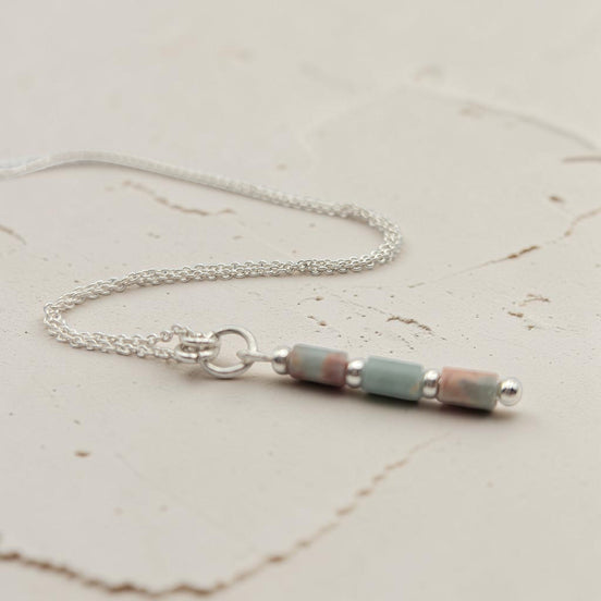 Bijou by SAM Big Sky Necklace featuring natural blue and pink Aqua Terra Jasper tube beads on a sterling silver chain.