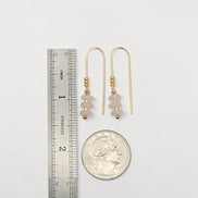 Bijou by SAM Aurora threader earrings featuring blush pink rose quartz beads on 14k gold fill wire next to a coin.