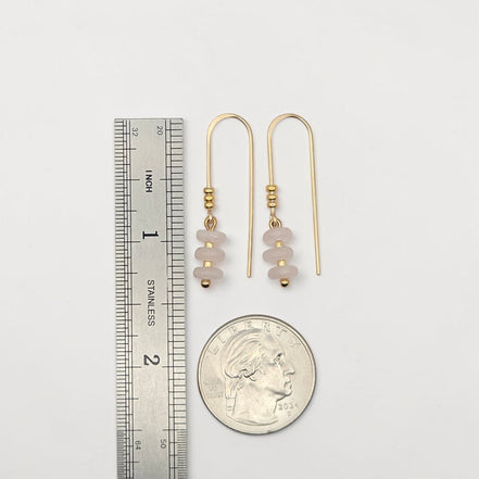Bijou by SAM Aurora threader earrings featuring blush pink rose quartz beads on 14k gold fill wire next to a coin.