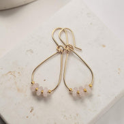Bijou by SAM Aurora teardrop hoop earrings featuring blush rose quartz beads on 14k gold fill wire.
