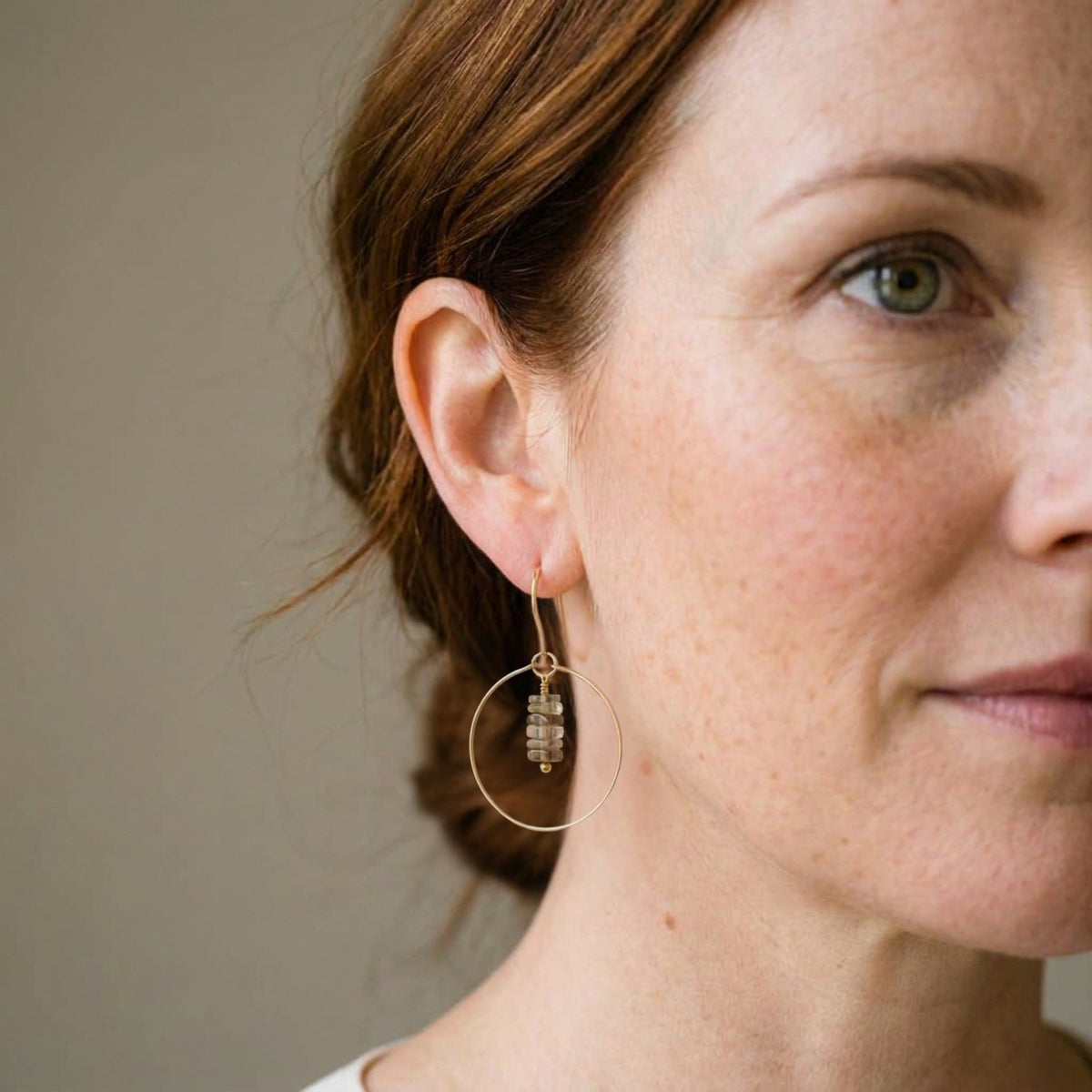 Bijou by SAM handmade gold hoop earrings featuring a delicate stack of square-cut bicolor quartz stones on a model