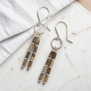 Bijou by SAM Canyon Earrings featuring natural Picture Jasper tube beads and sterling silver hoops on a marble surface.