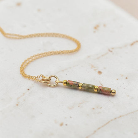 Bijou by SAM Forest Floor necklace with Unakite tube beads and 14k gold fill chain on a textured surface
