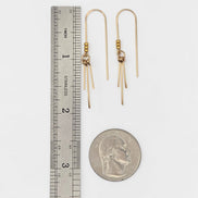 Bijou by SAM gold threader earrings featuring three delicate metal fringes, shown next to a ruler and US quarter.