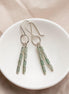 Bijou by SAM Mossy Creek earrings featuring green aventurine tube beads and sterling silver hoops in a white bowl.