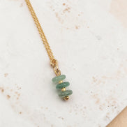 Bijou by SAM Comet necklace featuring three small green aventurine disc stones on a delicate gold chain