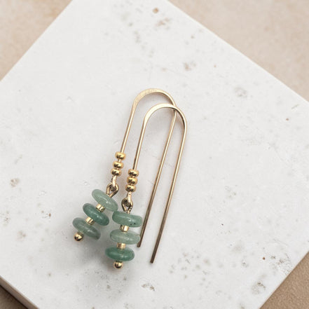 Bijou by SAM Comet Threader earrings featuring green aventurine beads and 14k gold fill on a textured white surface.
