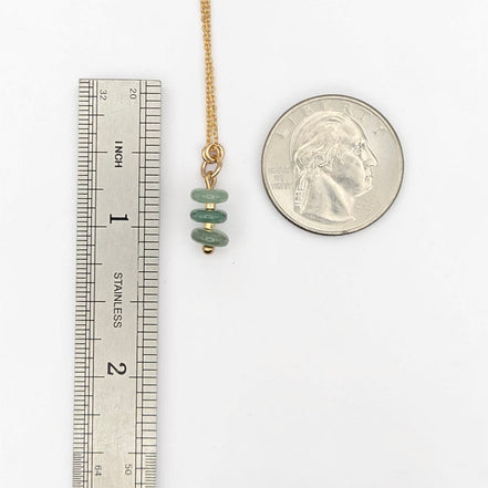 Bijou by SAM Comet necklace featuring three green aventurine stone beads on a delicate gold chain for scale.