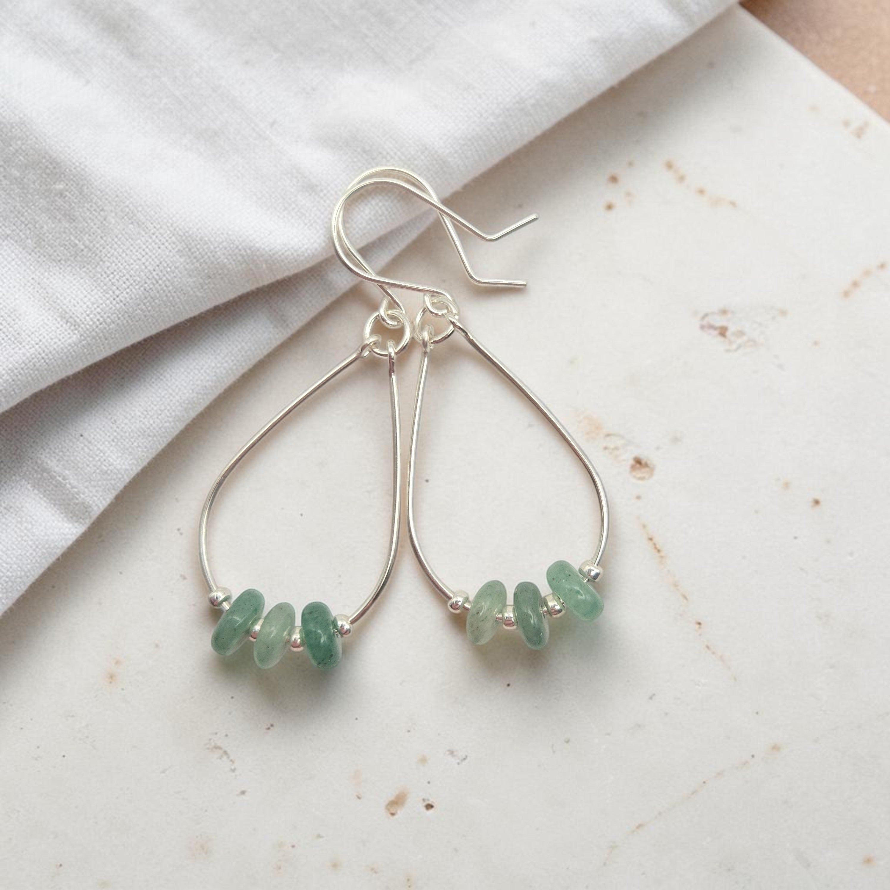Bijou by SAM Comet teardrop hoop earrings featuring green aventurine stones on handcrafted sterling silver wires.