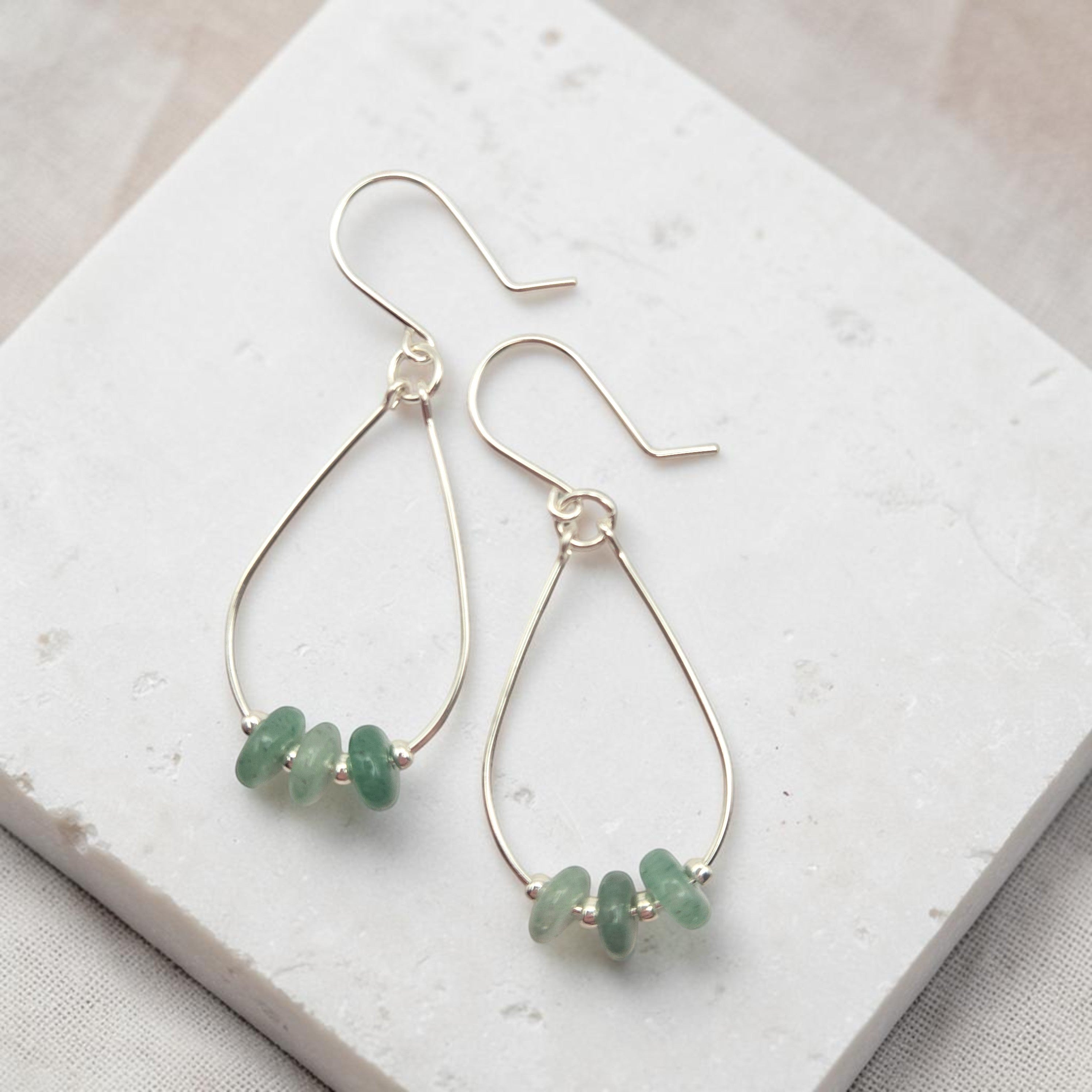 Bijou by SAM handmade sterling silver teardrop hoop earrings featuring small, shimmering green aventurine gemstones.