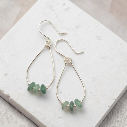 Bijou by SAM handmade sterling silver teardrop hoop earrings featuring small, shimmering green aventurine gemstones.