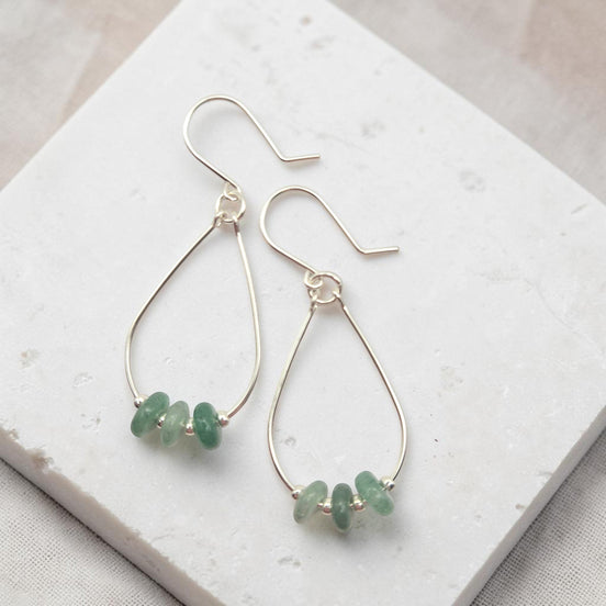 Bijou by SAM handmade sterling silver teardrop hoop earrings featuring small, shimmering green aventurine gemstones.