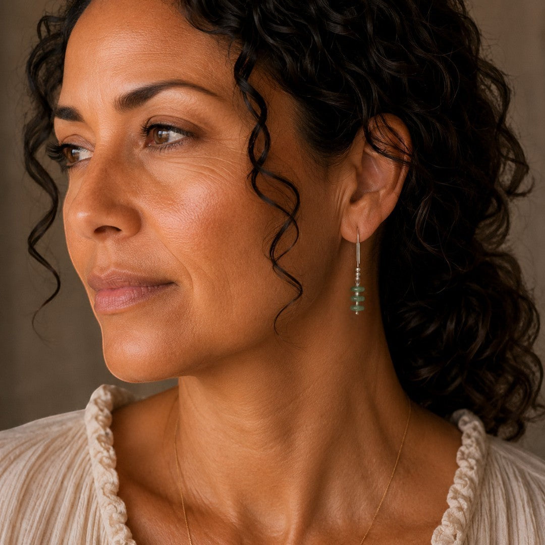 Bijou by SAM Comet threader earrings featuring green aventurine beads on a model wearing a cream top