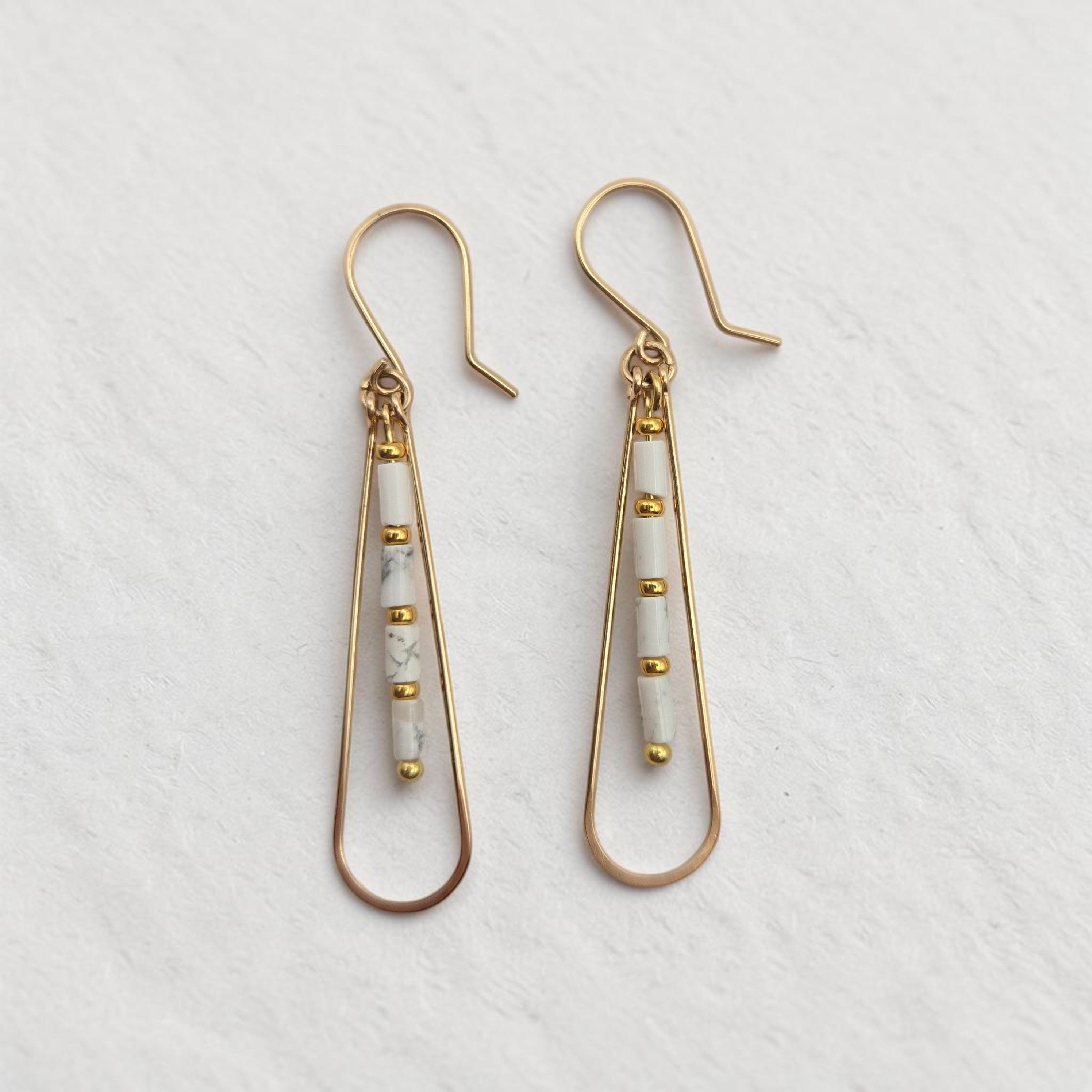 Bijou by SAM First Snow teardrop hoop earrings featuring white Howlite tube beads and 14k gold fill wire.