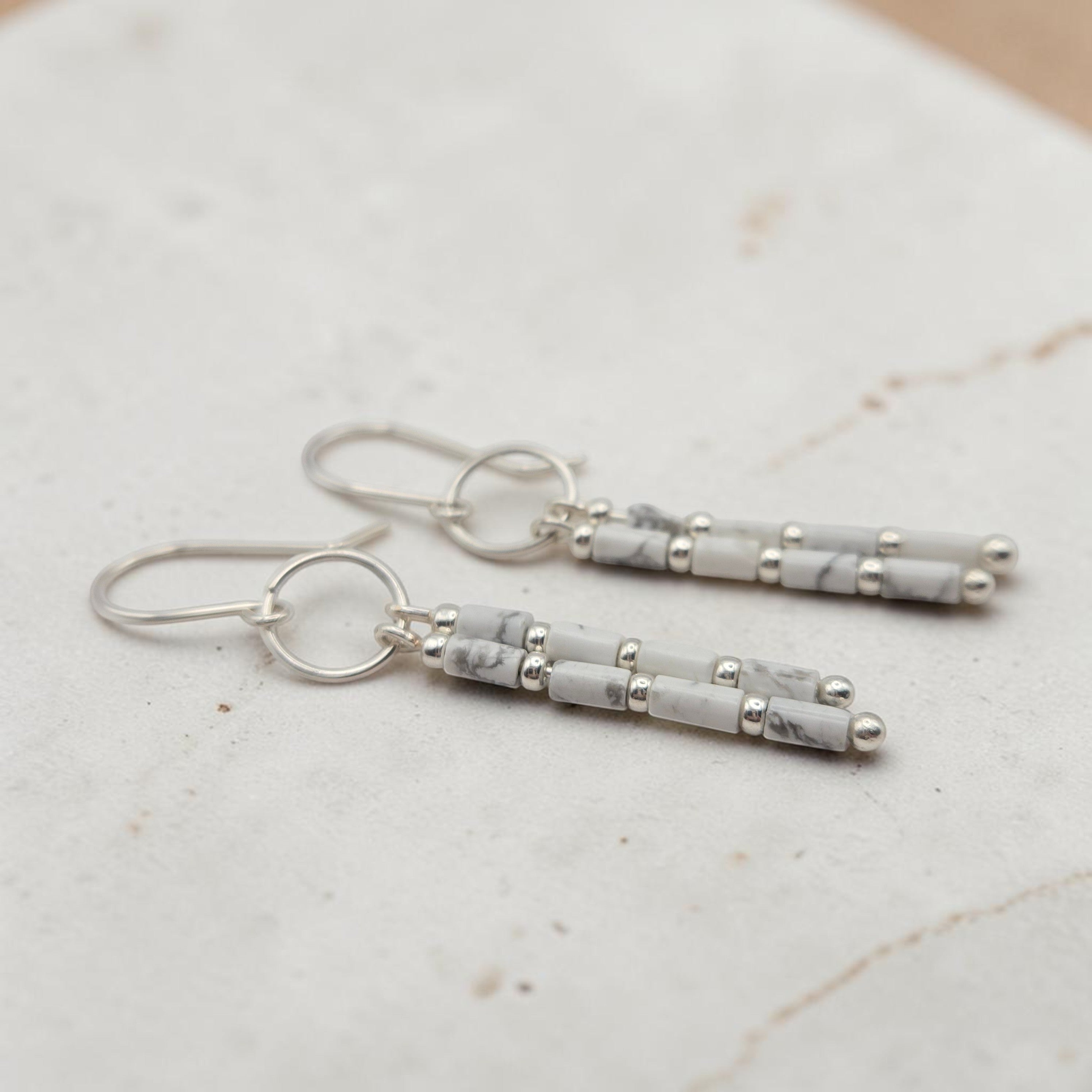 Bijou by SAM First Snow dangle earrings featuring white Howlite tube beads and Argentium Sterling Silver hoops.