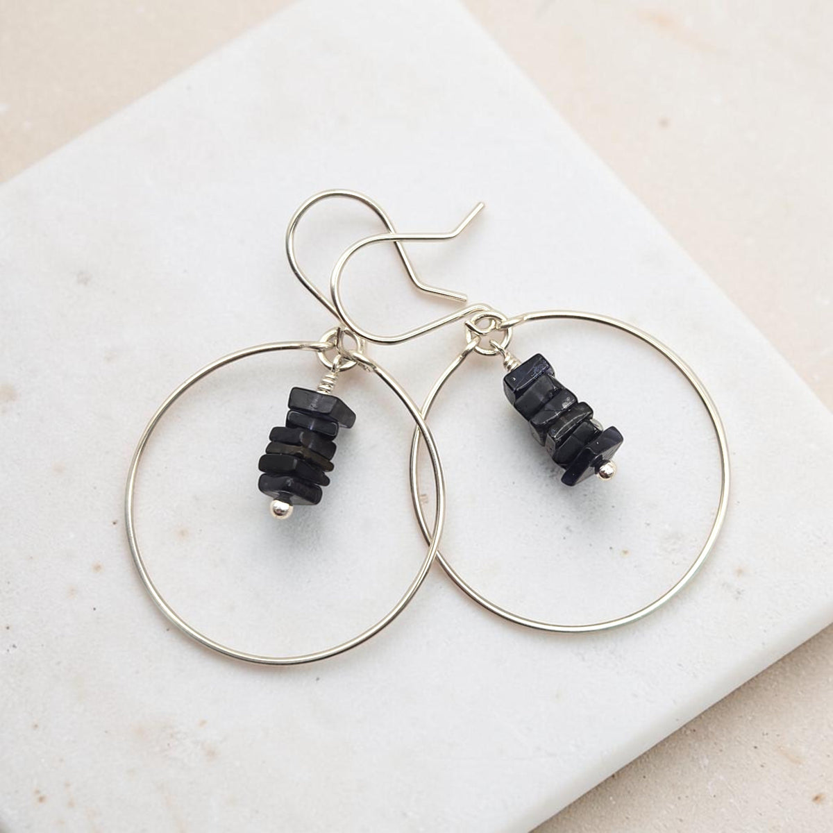 Bijou by SAM handmade hoop earrings featuring a delicate stack of square-cut deep blue iolite gemstones in silver.