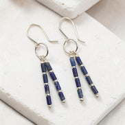 Bijou by SAM Midnight Sky earrings featuring deep blue Lapis Lazuli tube beads and silver spacers on hoop dangles.