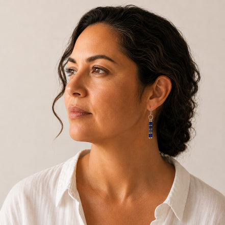 Bijou by SAM Midnight Sky earrings featuring blue Lapis Lazuli tube beads and silver dangles worn by a woman.