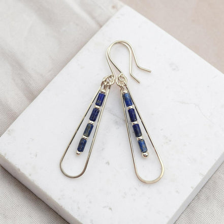Bijou by SAM Midnight Sky teardrop earrings featuring natural blue Lapis Lazuli tube beads on silver hoops.