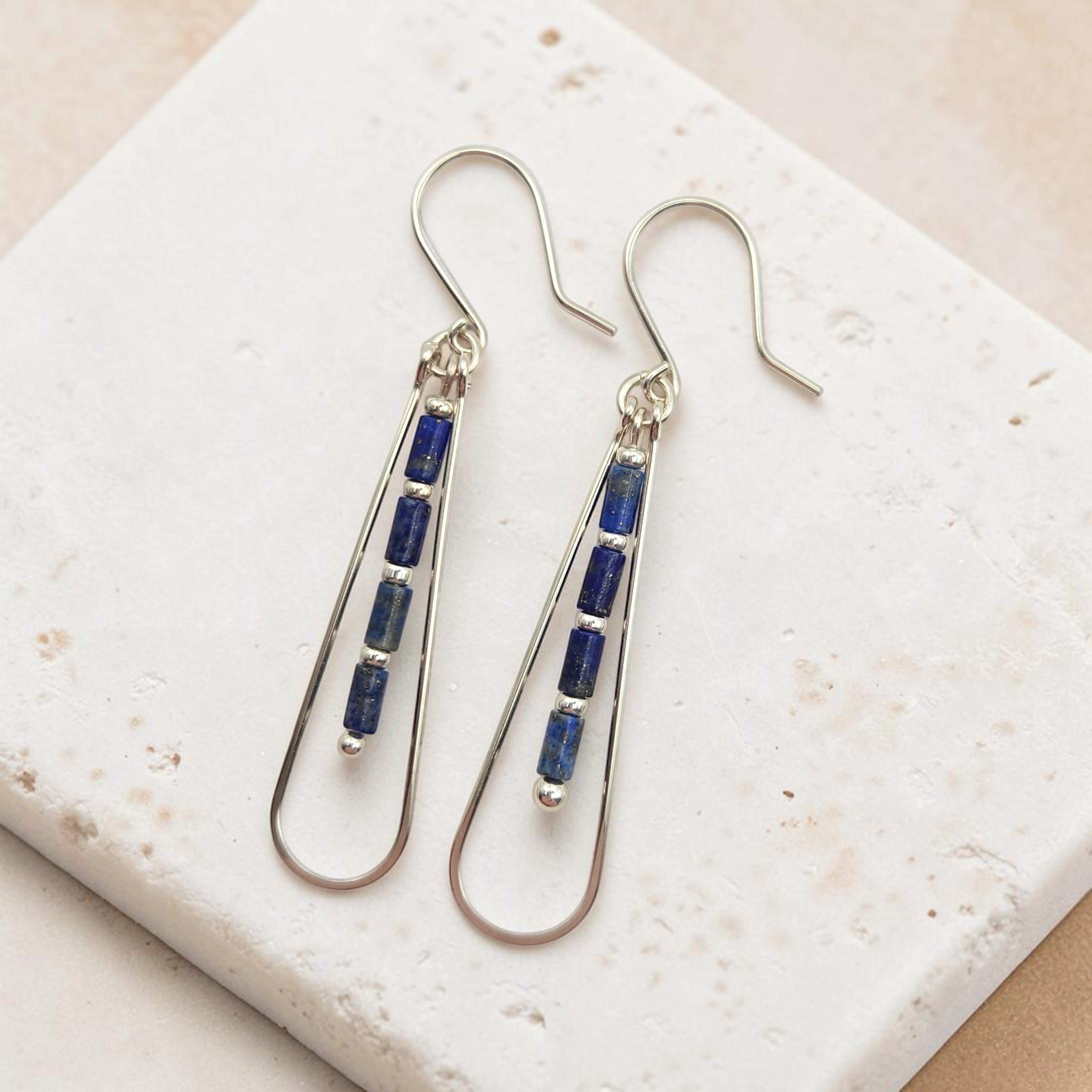 Bijou by SAM Midnight Sky teardrop earrings featuring blue Lapis Lazuli tube beads on silver hoops.