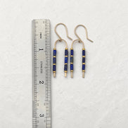 Bijou by SAM wishbone earrings featuring blue lapis lazuli tube stones and gold fill wire next to a metal ruler.