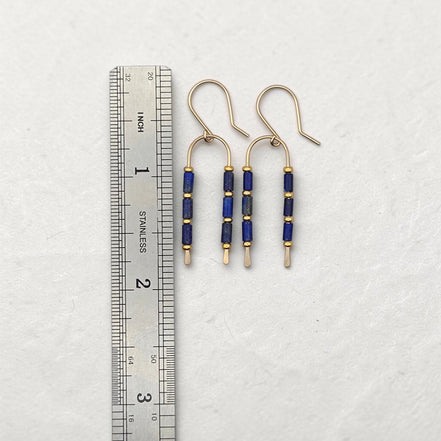 Bijou by SAM wishbone earrings featuring blue lapis lazuli tube stones and gold fill wire next to a metal ruler.