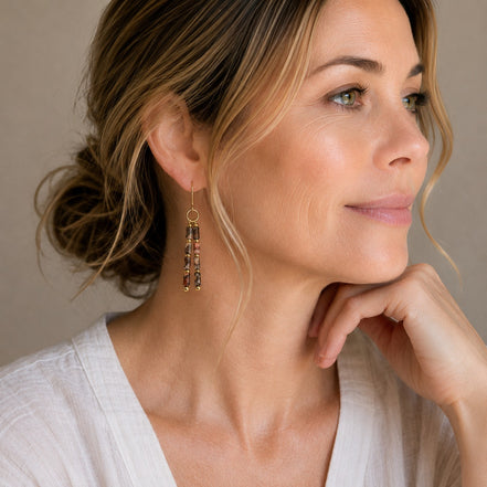 Bijou by SAM Wild Mesa earrings featuring leopard skin jasper tube beads and 14k gold fill hoops worn by a woman