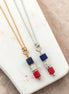 Bijou by SAM Liberty necklace set featuring red, white, and blue sea sediment jasper cube pendants on gold and silver chains.
