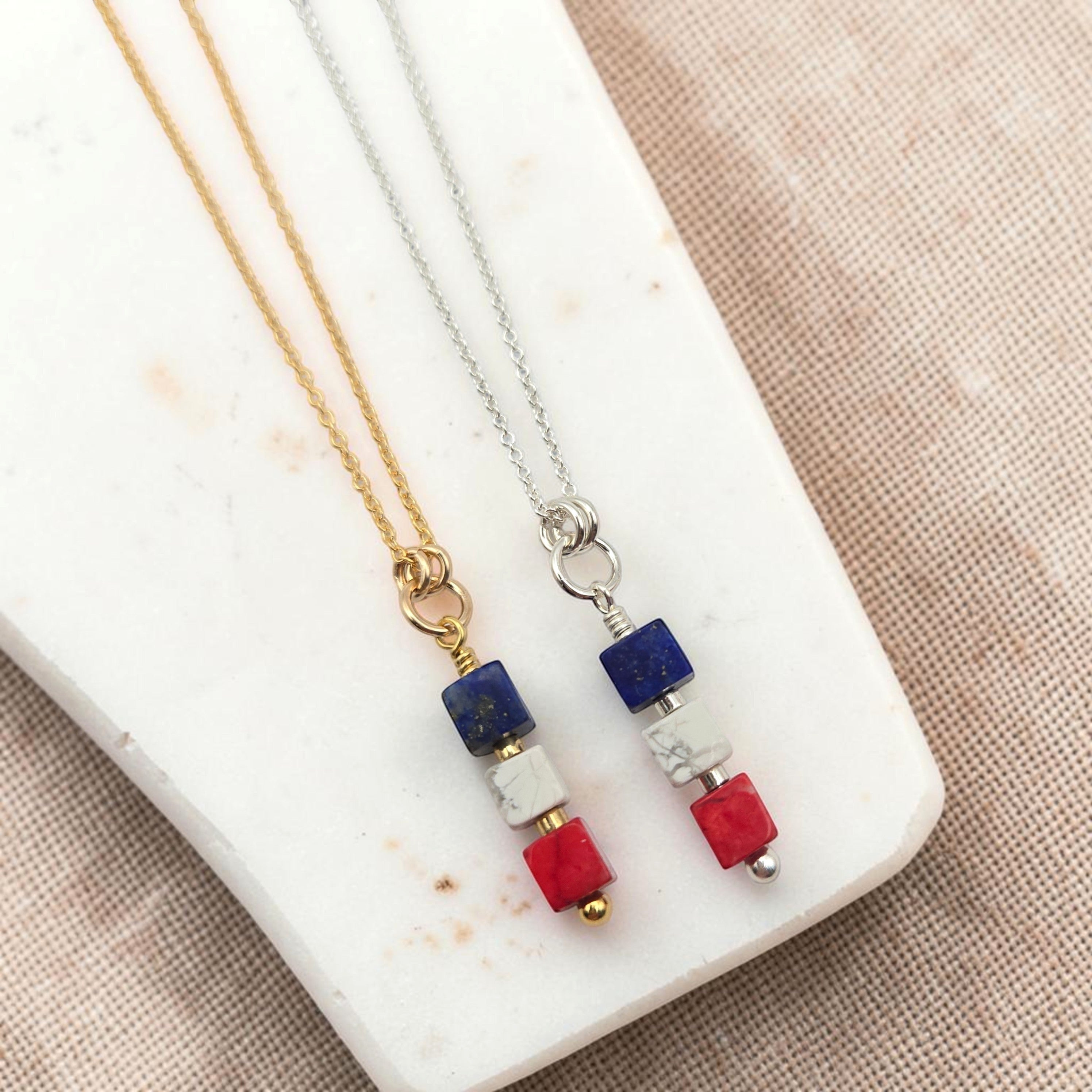 Bijou by SAM Liberty necklace set featuring red, white, and blue sea sediment jasper cube pendants on gold and silver chains.