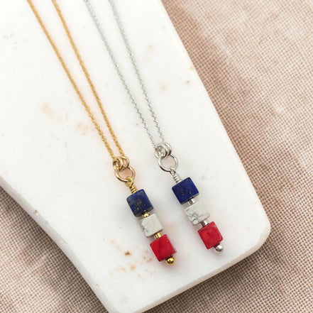 Bijou by SAM Liberty necklace set featuring red, white, and blue sea sediment jasper cube pendants on gold and silver chains.